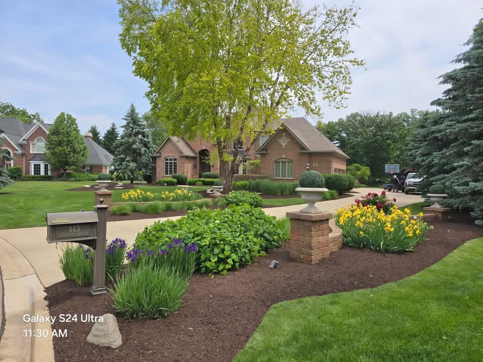 Beautiful residential lawn with fresh mulch and colorful flower beds