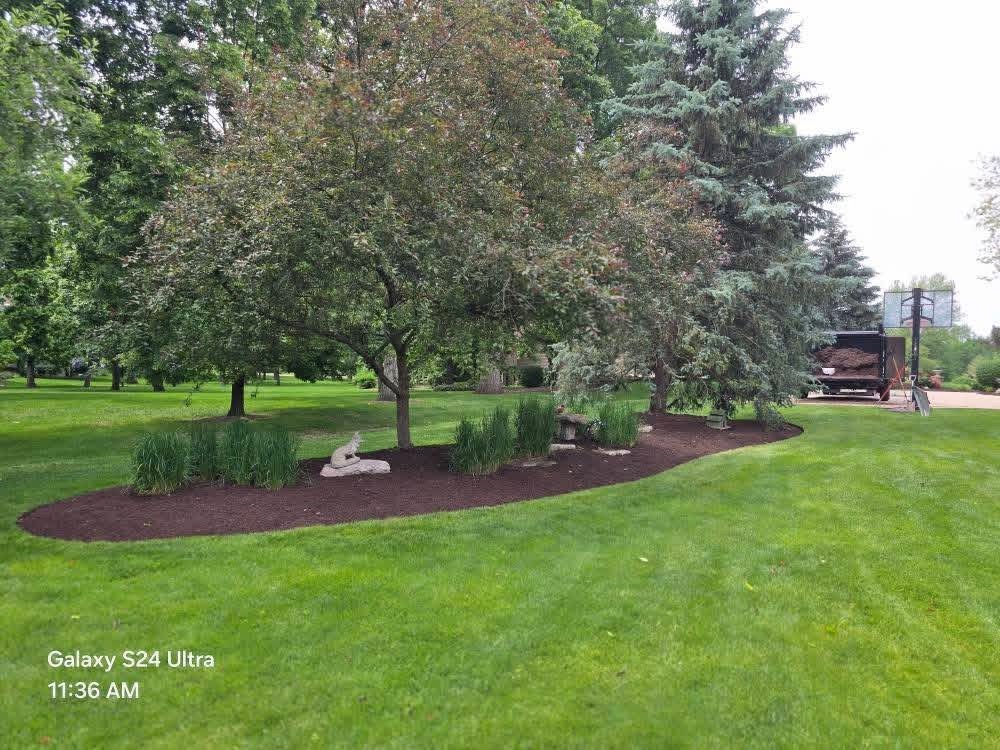 Large lawn with freshly maintained landscape beds
